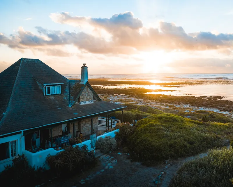 Beach house overlooking the ocean at sunset