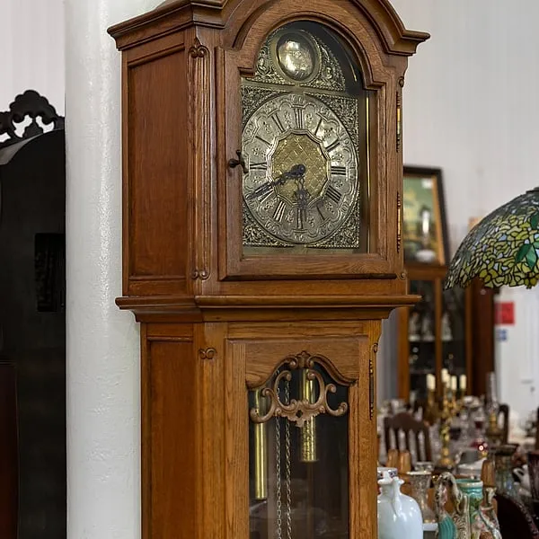 Antique longcase clock with an engraved brass face