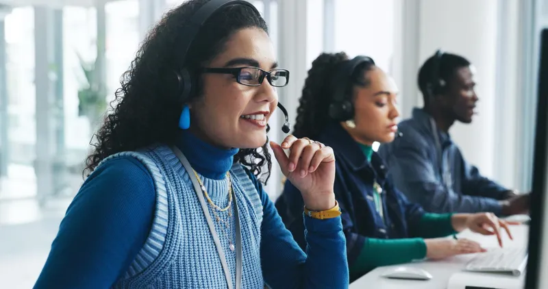 Support team taking calls side by side in an office